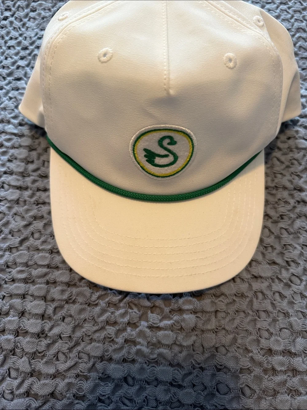 White woman's golf  Cap with Green Trim and Swan Logo.